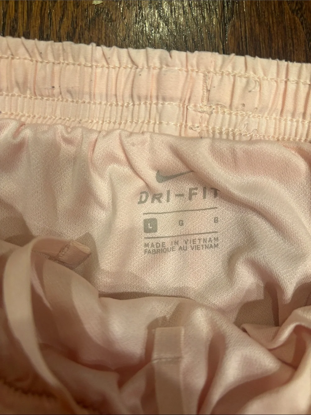 Nike Girl’s Light Pink Athletic Shorts with Red Trim